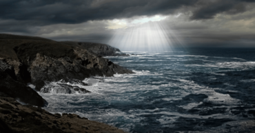 Dark Storm Clouds With Sunlight Breaking Through