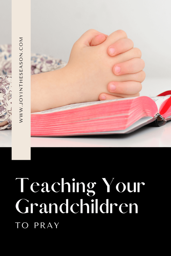 Child’s Hands Folded In Prayer On Bible