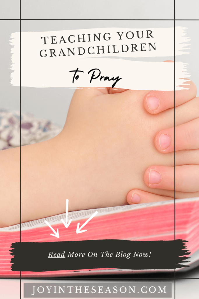 Child’s Hands Folded In Prayer On Bible